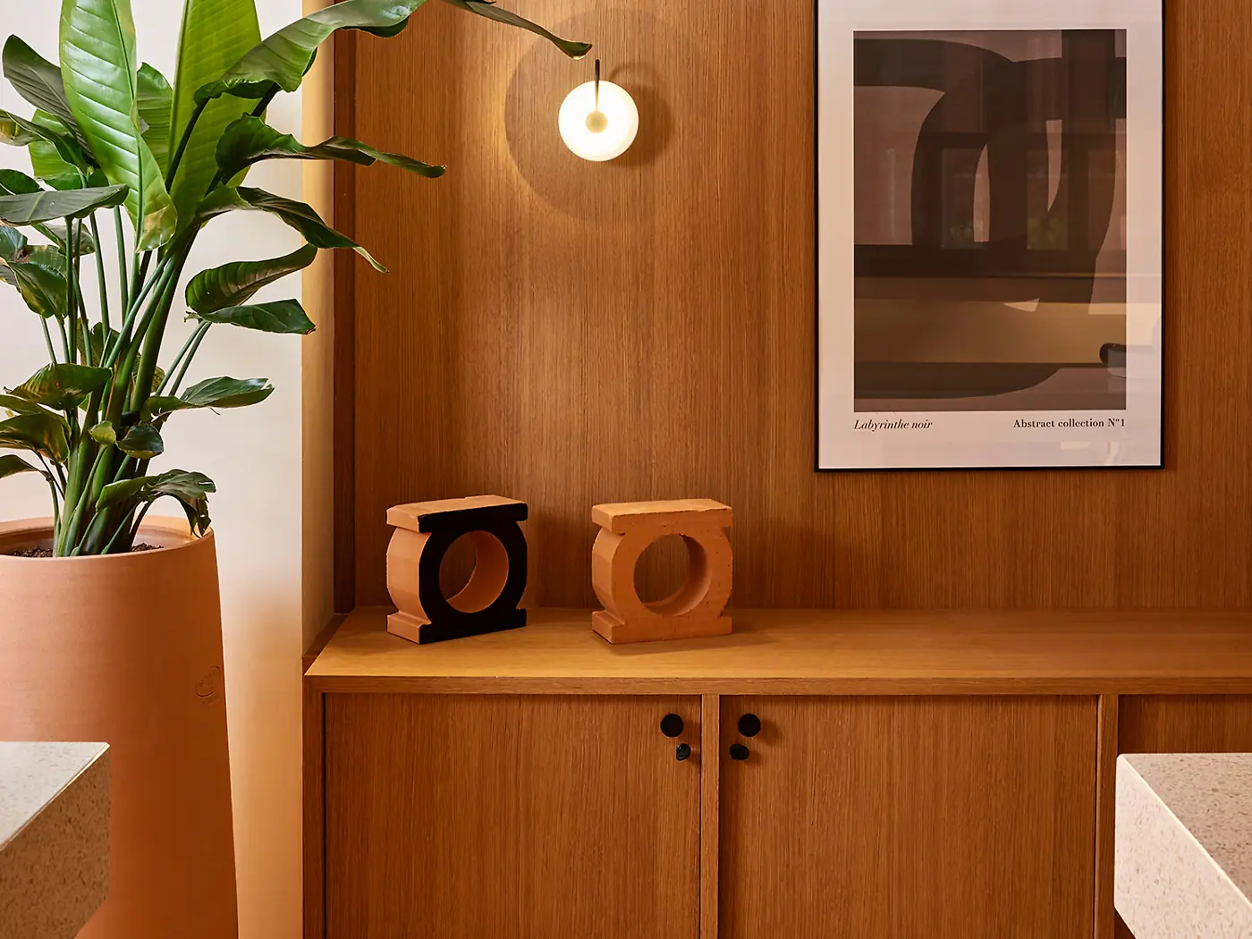 Oak veneered cabinetry and wall panelling in a fitted interior